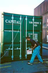 Man examining a shipping container